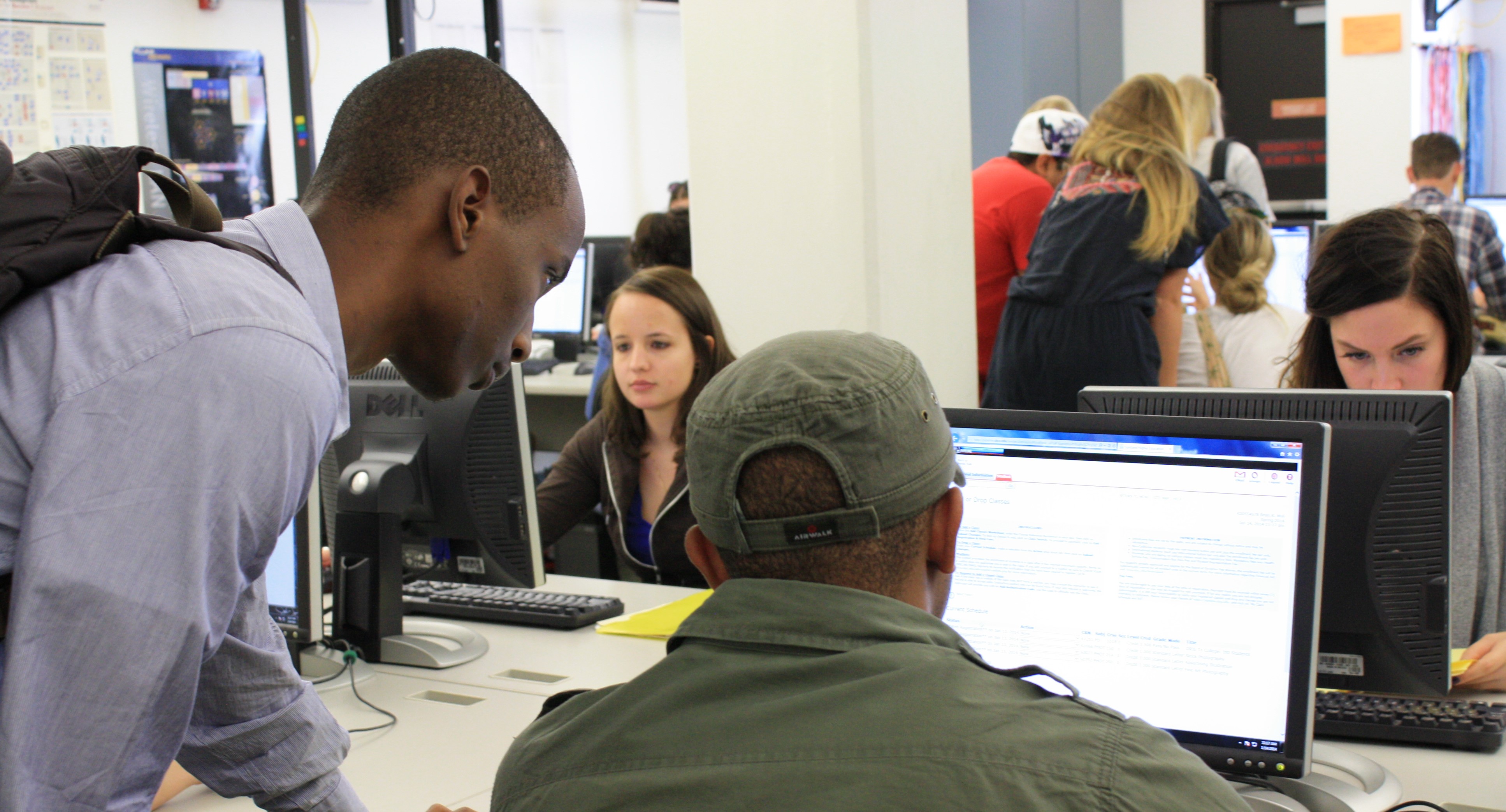 students hovering over computers